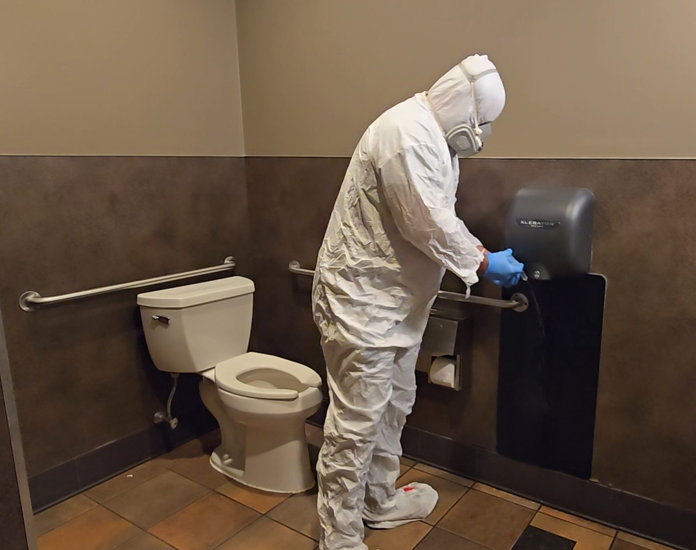 Sampling a hand dryer in protective gear